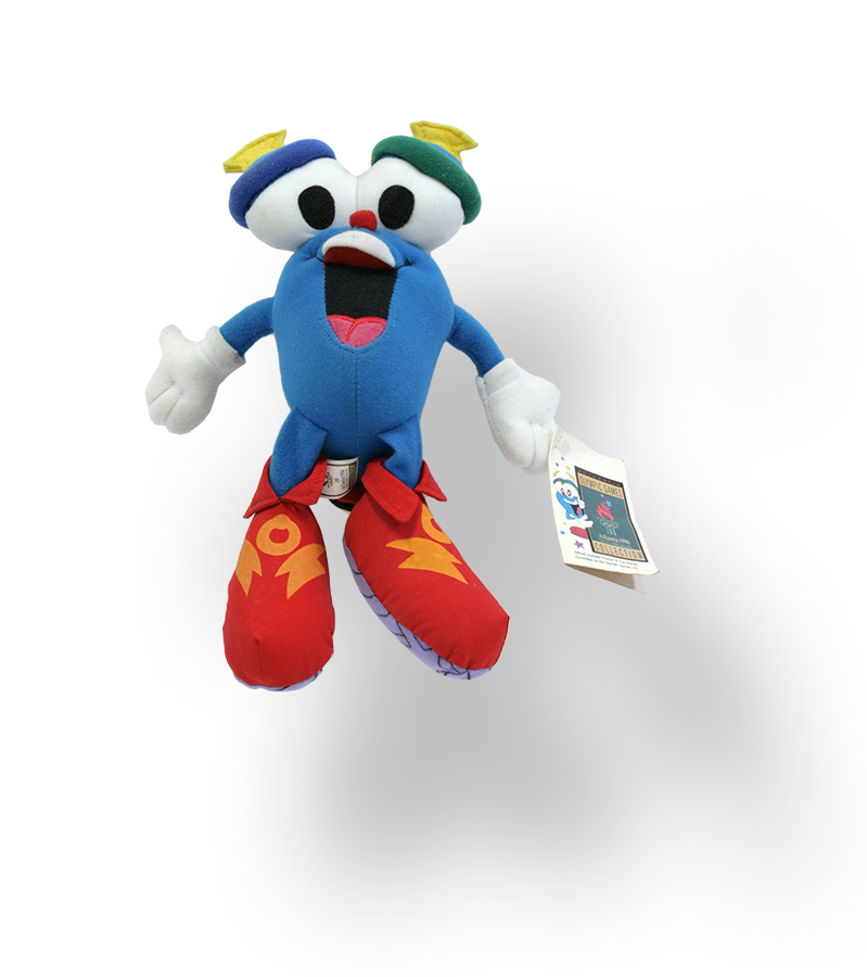 Blaue Plüschfigur mit roten Schuhen